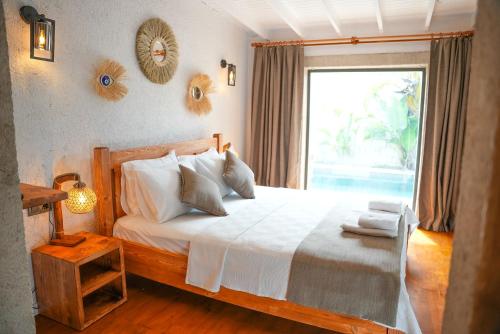 a bedroom with a white bed with a window at Armi Alaçatı in Cesme