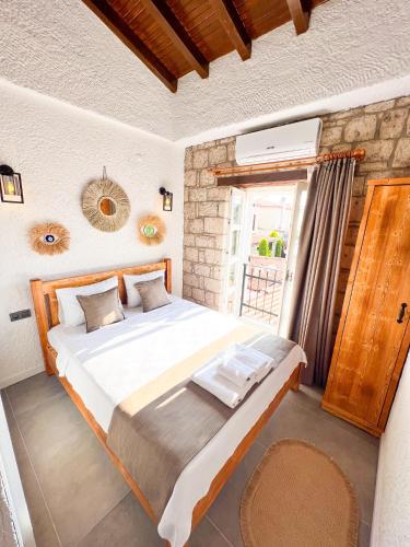 a bedroom with a large bed and a window at Armi Alaçatı in Cesme