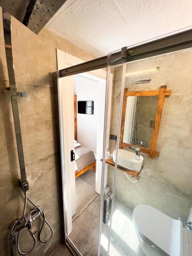 a bathroom with a shower and a sink and a toilet at Armi Alaçatı in Cesme