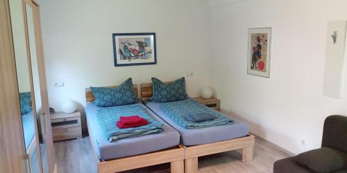 a small bedroom with a bed with blue pillows at Ferienwohnung in Grenzach in Grenzach-Wyhlen