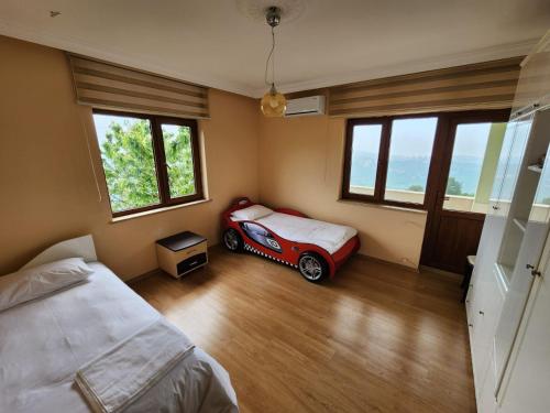 a bedroom with a bed and a red car in it at Heaven Twın Villa in Zafanos
