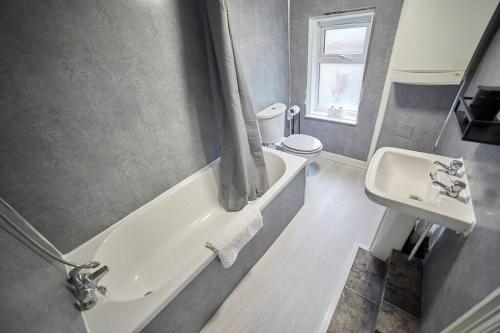a bathroom with a tub and a sink and a toilet at Flat in Gateshead in Gateshead