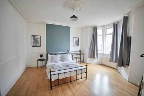 a bedroom with a bed and two chairs in it at Flat in Gateshead in Gateshead