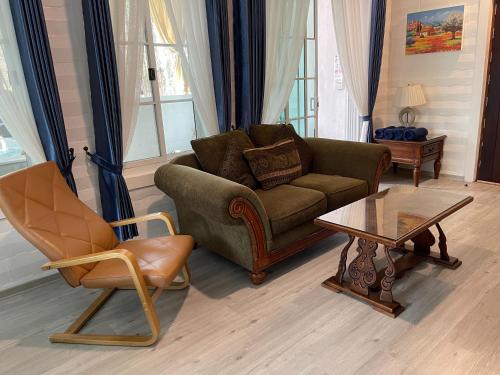 a living room with a couch and a coffee table at Villa PaSon in Khao Kho