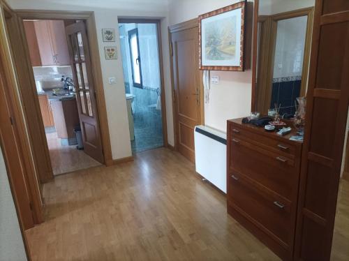 a kitchen with wooden floors and a kitchen with a sink at Casa Víctor in Ciudad-Rodrigo