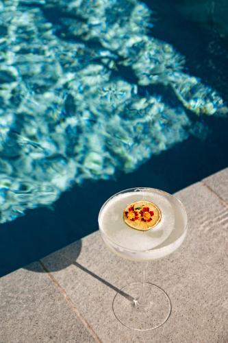 a small pizza on a plate next to the water at Villars Palace in Villars-sur-Ollon