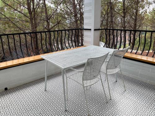 a table and two chairs on a balcony at Villa PaSon in Khao Kho