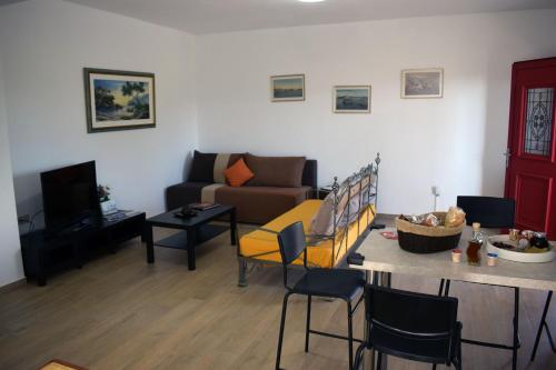 a living room with a couch and a table at Κτήμα Κωνσταντινίδη in Preveza