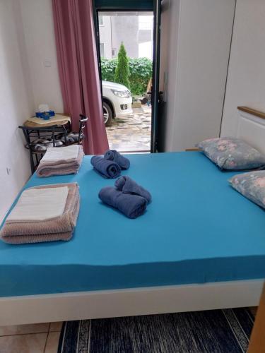 a bedroom with a bed with towels on it at Sobe Kraft 1 in Živogošće