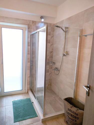 a shower with a glass door in a bathroom at Κτήμα Κωνσταντινίδη in Preveza