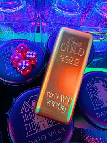 a close up of a gold ingot and poker chips at Dato Villa Luxury Homestay 12min to Jonker Street 26pax Private Pool Playground KTV BBQ in Melaka