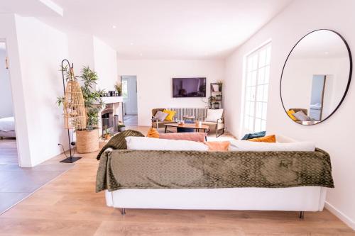 a living room with a bed and a mirror at Property with heated pool near Deauville in Saint-Étienne-la-Thillaye