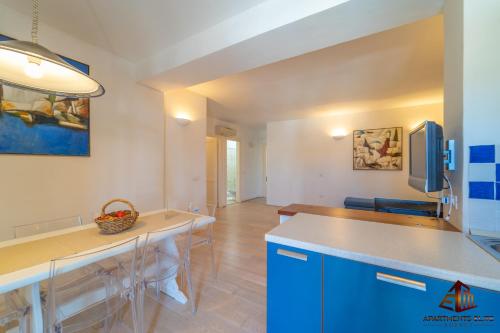 a kitchen and dining room with a table and chairs at Porto Rotondo Central House in Porto Rotondo