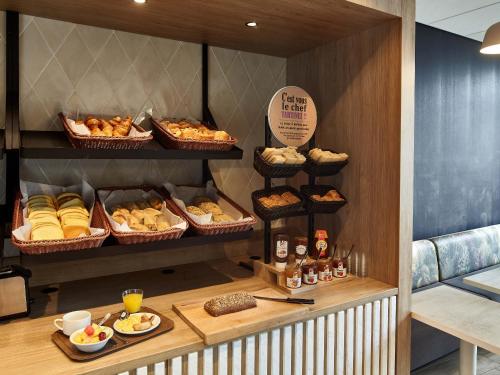a bakery with many different types of bread and pastries at B&B HOTEL Cluses Sud in Cluses