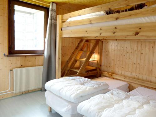 deux lits dans une chambre aux murs en bois dans l'établissement Appartement rénové 8p à Tignes · Proche pistes et commerces · Balcon · Sud · Animaux acceptés - FR-1-502-508, à Tignes