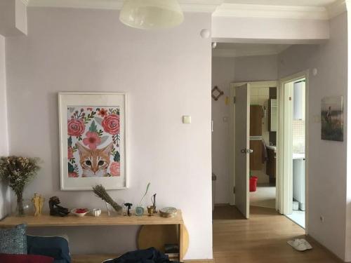 a living room with a table and a picture on the wall at Bright apartment in Beşiktaş / Abbasağa in Istanbul