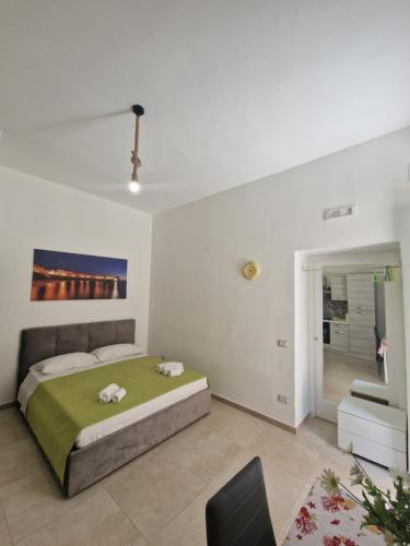 a bedroom with a bed and a chair in it at AP Apartment - in centro! in Gallipoli
