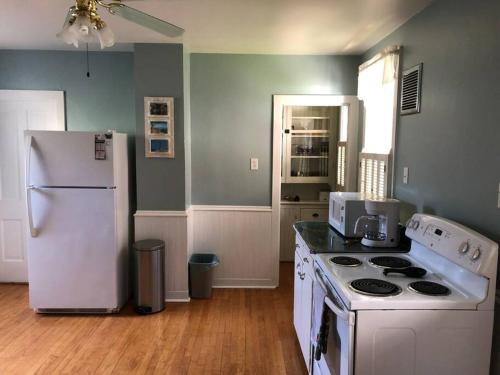 a kitchen with a white refrigerator and a stove at Spacious & Peaceful Home in the heart of Sheboygan in Sheboygan