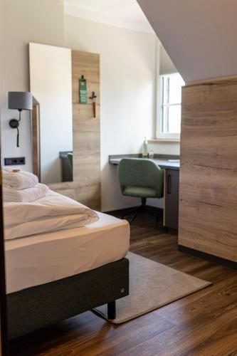 a bedroom with a bed and a desk and a chair at Lieb&Wert in Raesfeld