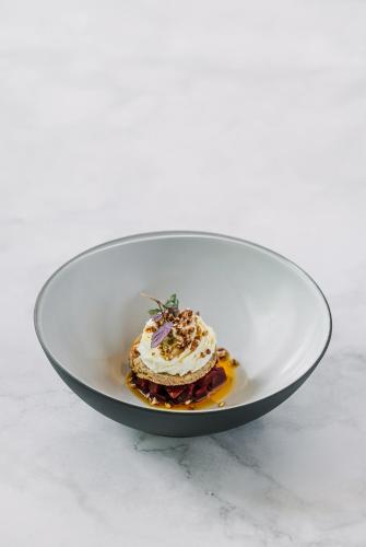 a white plate with a dessert on a table at Boutique Hotel Sunrose 7 - Gourmet & SPA in Bohinj