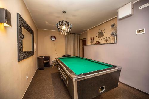a room with a pool table in it at Hotel Stoh in Špindlerův Mlýn