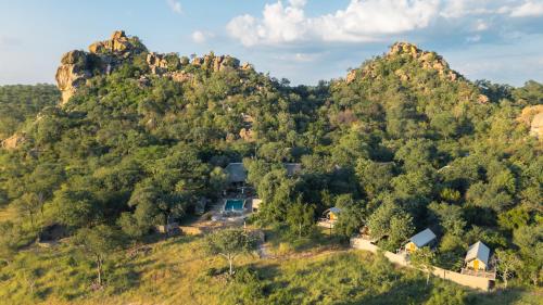 an aerial view of a mountain with houses and trees at MILIMA Big 5 Safari Lodge in Hoedspruit