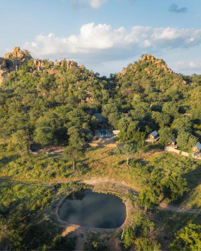 an aerial view of a hill with a lake at MILIMA Big 5 Safari Lodge in Hoedspruit