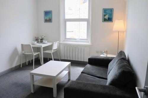 a living room with a couch and a table at Pier12 in Eastbourne