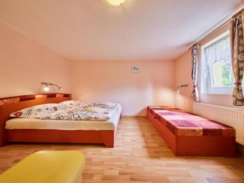 a bedroom with two beds and a window and a bench at Studio U Šustrů by Interhome in Horní Maršov