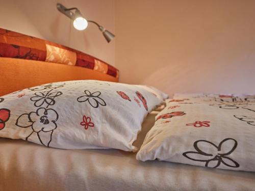 a bed with two pillows on it with a lamp at Studio U Šustrů by Interhome in Horní Maršov
