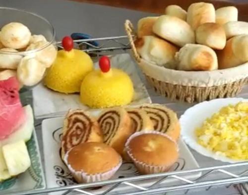 a tray of pastries and other foods on a shelf at Mar Turquesa Eco Pousada in Maragogi