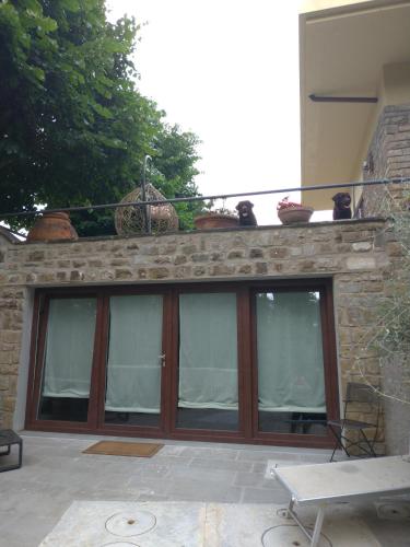 a patio with glass doors and a balcony with plants at Poggio Gherardo in Florence