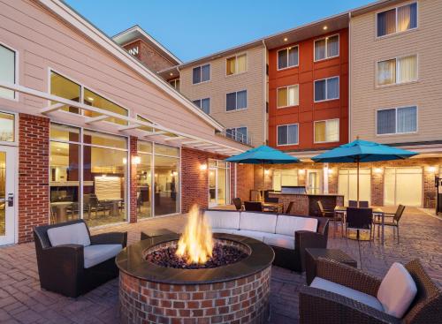 a patio with a fire pit in front of a building at Residence Inn by Marriott Greenville in Greenville
