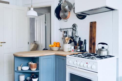 a kitchen with a blue and white stove top oven at A wonderful room in Sale