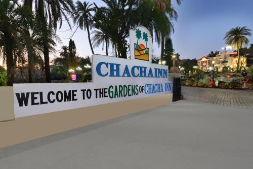 a sign for a gate with a welcome to the caragogickedicked in at Chacha Inn The Garden Retreat in Mount Ābu