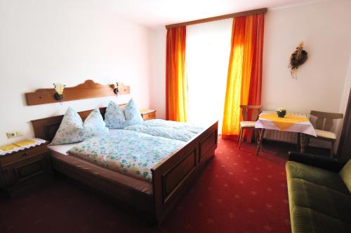 a bedroom with a bed and a window at Buttermilchalm in Sankt Martin am Tennengebirge