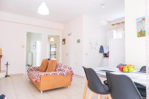 a living room with a table and a couch at Vereniki 2 in Kriopigi