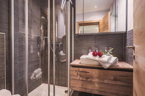 a bathroom with a shower and a sink and a toilet at Apart Dengg in Mayrhofen