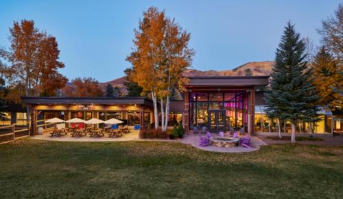 um edifício com mesas e cadeiras num quintal em The Inn at Aspen em Aspen