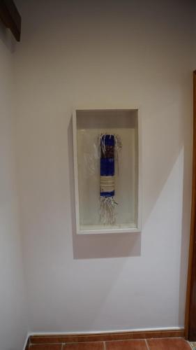 a white wall with a painting on it at riad casa bahia asilah in Asilah
