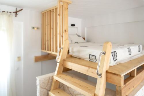 a bedroom with a bunk bed and a staircase at Kellys house in Epanomi