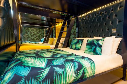 a bedroom with a bed with a black head board at The Shankly Hotel in Liverpool