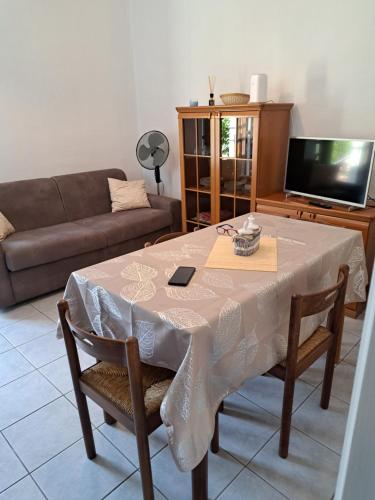 a living room with a table and a couch at Green & Blue House in Valbrona