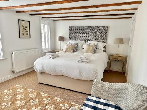 a bedroom with a large white bed in a room at Laurel Cottage Sandsend in Sandsend