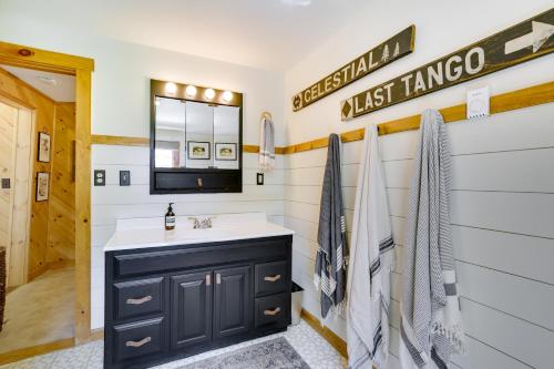a bathroom with a sink and a mirror at Gorgeous Sunday River Cabin with Saltwater Hot Tub! in Newry