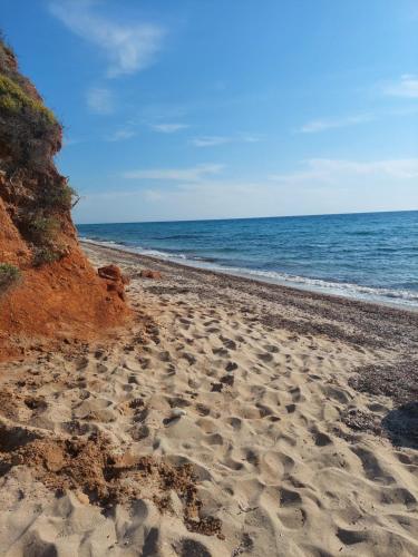 a sandy beach with the ocean in the background at Tasos in Nea Potidaea