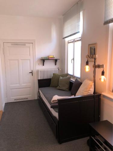 a couch sitting in a living room with a window at In der Mühlenstraße in Malchow