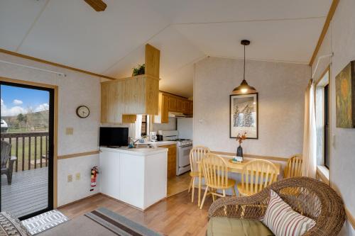 a kitchen and dining room with a table and chairs at Thousand Trails Blue Mesa Recreational Ranch in Hierro