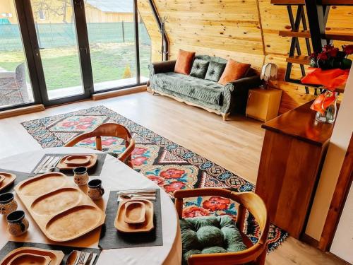 a living room with a table with food on it at Casuta mea in Stulpicani