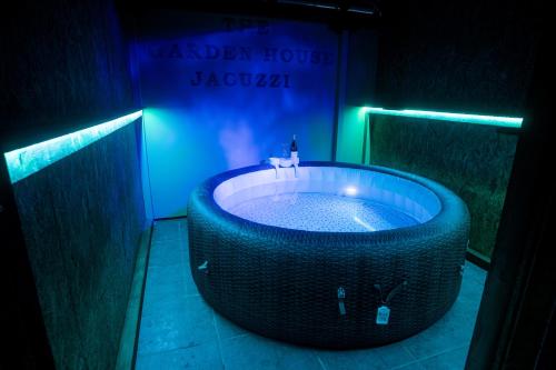 a large bath tub in a room with a blue light at The Garden House in Zakharo